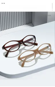 Detailed shot of tortoiseshell and beige oval eyeglass frames with metal hinge craftsmanship