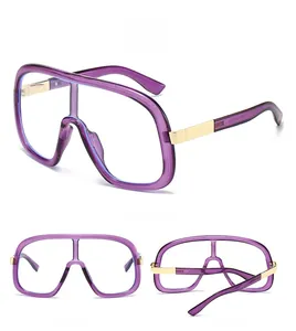Detail view of purple one-piece shield sunglasses with elegant gold metal temples