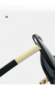 Detail of premium gold metal hinge and polished black frame on fashion sunglasses
