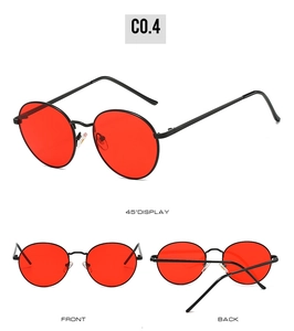Vue détaillée de lunettes de soleil rondes rétro avec monture en métal noir et verres rouges