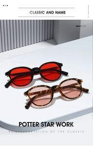Détail des lunettes de soleil rondes vintage noires avec verres rouges et monture écaillée