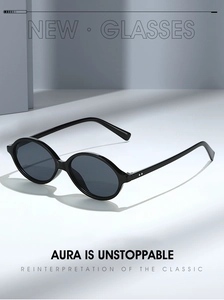 Close-up of retro oval sunglasses with silver rivet details and dark lenses