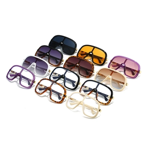 Set of 12 oversized flat-top sunglasses in diverse colors on a white background