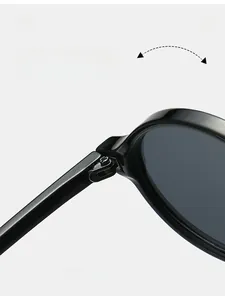 Close-up of durable metal hinge on vintage black oval sunglasses with glossy finish