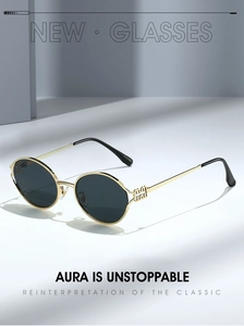 Detail view of round metal sunglasses with gold geometric hollow temples and grey lenses