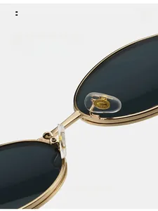 Close-up of comfortable silicone nose pads on round metal sunglasses frame