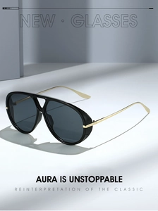 Detail of aviator sunglasses featuring a black frame and elegant gold metal temples