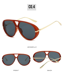 Detail view of aviator sunglasses with orange translucent frames and gold metal temples