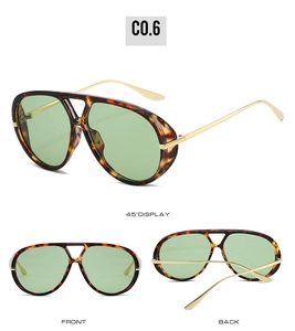 Detail view of tortoiseshell aviator sunglasses with green lenses and gold metal temples