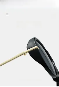 Close-up of black frames with golden metal hinges on stylish aviator sunglasses