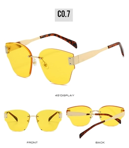 Front, back and side views of rimless sunglasses with yellow lenses and gold metal frames
