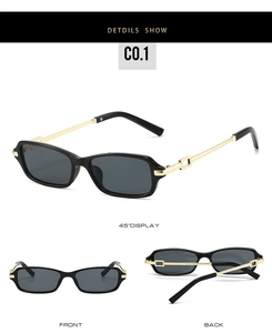 Detailed view of black rectangular sunglasses with golden metal temples and hollow hinges