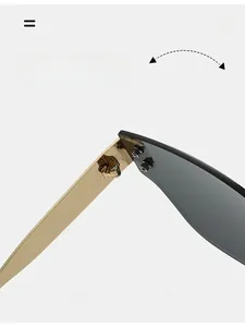 Close-up of durable golden metal hinges on rimless sunglasses with gradient grey lenses
