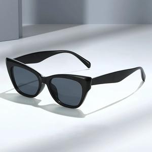 Classic black cat-eye sunglasses with dark UV protection lenses on geometric blocks