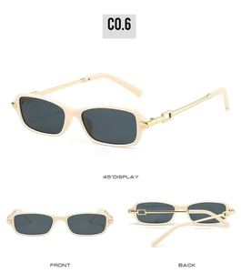 Detail view of cream rectangle sunglasses with golden metal temples and side cutouts