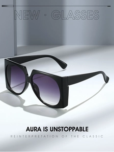 Detail of oversized black sunglasses with purple gradient lenses and chic thick frame