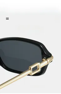 Detail of square sunglasses featuring golden metal hinges and lightweight elastic frame