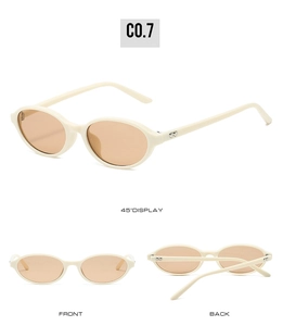 Detail of oval frame sunglasses with cream frames and heart metal temple accents