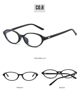 Detail view of oval black sunglasses with heart-shaped metal accents on the temples