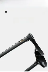 Detailed macro view of the gold heart metal ornament on black oval sunglasses frame