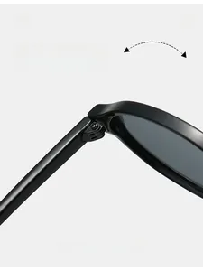 Macro detail showing durable metal hinges of these oval retro sunglasses in black