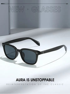 Close-up of black oversized square sunglasses with silver rivets and dark polarized lenses