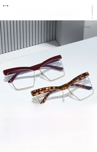 Detail of burgundy and tortoiseshell cat-eye glasses on a white minimalist pedestal