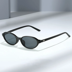 Retro oval black frame sunglasses with heart metal details and smoke lenses