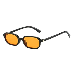 Retro small frame sunglasses with black thick resin frames and orange lenses in side view
