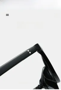Detail of lightweight black sunglasses frame featuring dual metal dot studs and hinges