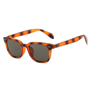 Fashionable oversized square tortoiseshell sunglasses with dark grey lenses for driving