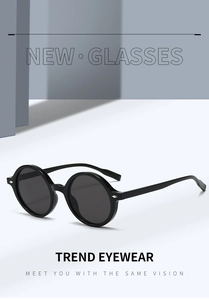 Détail de lunettes de soleil ovales rétro avec monture noire et rivets argentés