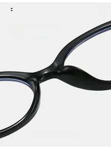 Detailed macro view of the integrated nose pads and sleek bridge on black oval frames