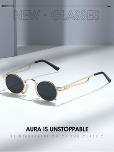 Detail of vintage round sunglasses with gold metal frame and hollow double bridge design