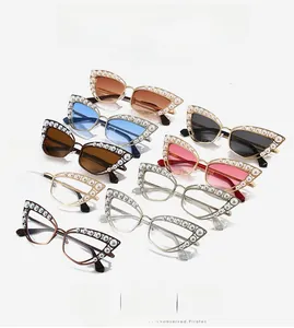Detailed view of ornate cat-eye sunglasses featuring elegant pearl-encrusted metal frames