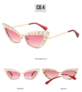 Detailed view of cat eye sunglasses with gold frame, pearls and pink gradient lenses
