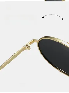 Close-up of durable metal hinges and golden frame on retro oval sunglasses
