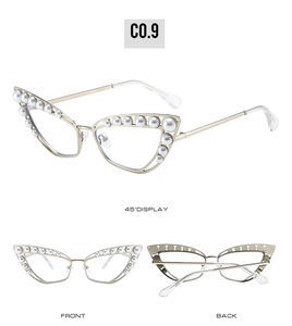 Detail view of cat-eye metal sunglasses featuring elegant pearl embellishments and gold frame