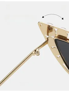 Detail of durable reinforced metal hinge on gold sunglasses with pearl accents