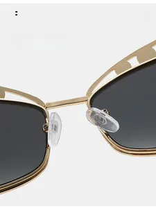 Detail of comfortable silicone nose pads on gold metal sunglasses with ornate frame design