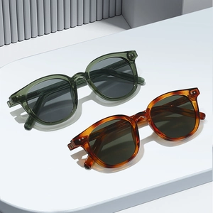 Retro sunglasses in translucent green and tortoiseshell frames with silver rivets