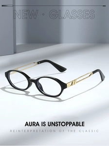 Detail of retro oval glasses with black frames and golden hollow geometric metal temples