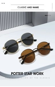 Détail de lunettes de soleil rondes rétro en métal avec verres polarisés or et sombre