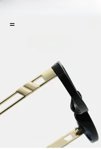 Detail of black resin frame and golden hollowed geometric metal temples on glasses
