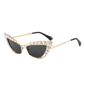 Elegant cat eye sunglasses with gold metal frame and pearl trim on black lenses