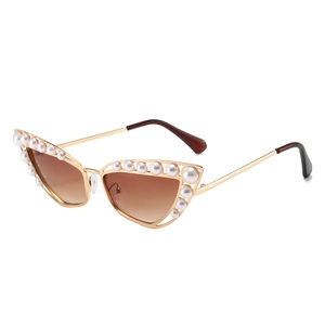 Elegant cat-eye sunglasses with gold metal frame and pearl accents on white background