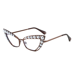 Luxury cat-eye metal sunglasses with pearl accents and brown frames on white background