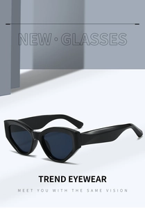 Close-up of trendy black cat-eye sunglasses with thick geometric frames and dark lenses
