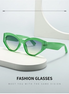 Detail of green cat-eye sunglasses with gradient lenses on a minimalist display