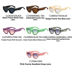 Flat lay of cat-eye sunglasses in multiple colors like green, black and tortoiseshell